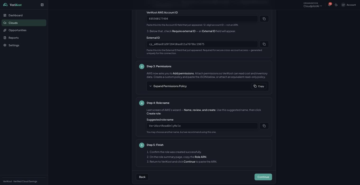 The VeriKost connection wizard showing the exact account ID, external ID, permissions policy and suggested role name to create in AWS